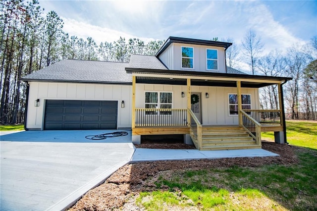 modern inspired farmhouse with a shingled roof, covered porch, an attached garage, board and batten siding, and driveway