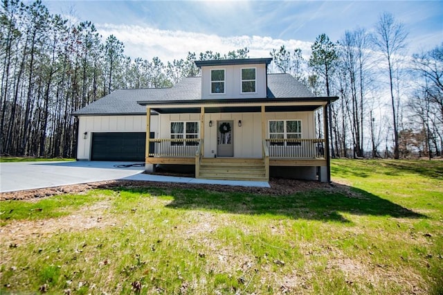 view of front facade with covered porch, board and batten siding, a front yard, a garage, and driveway