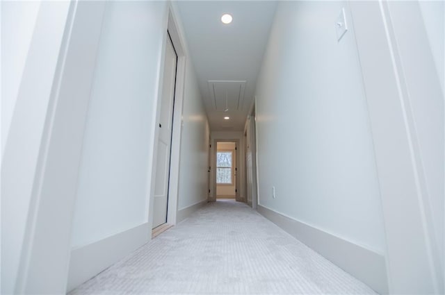 corridor featuring light carpet, attic access, and recessed lighting