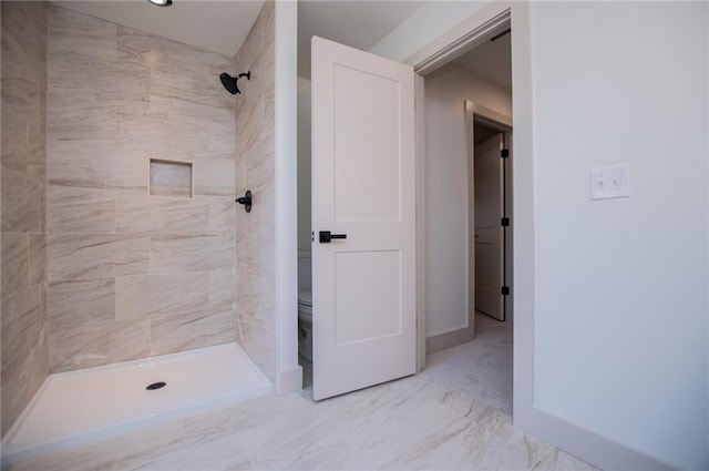 full bath featuring marble finish floor, baseboards, a shower stall, and toilet