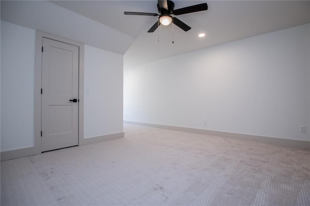 carpeted empty room with ceiling fan, baseboards, vaulted ceiling, and recessed lighting