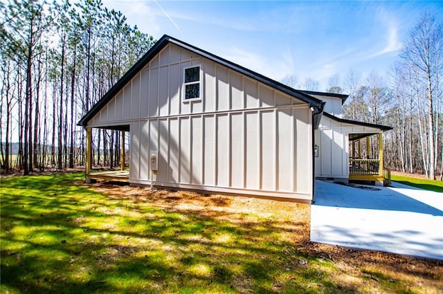 view of side of home with a lawn and board and batten siding