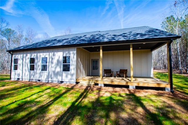 back of property featuring a shingled roof, crawl space, a yard, and a deck