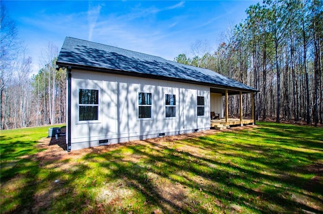 view of home's exterior with a yard, crawl space, and roof with shingles