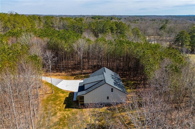 birds eye view of property featuring a view of trees