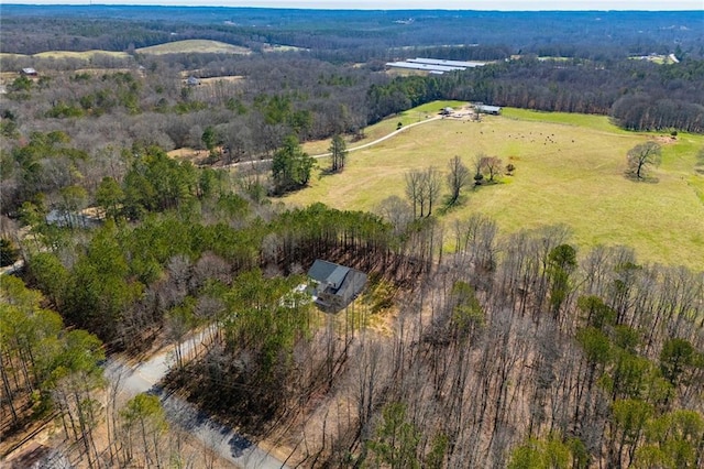 birds eye view of property with a wooded view