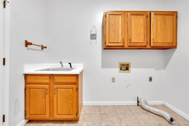 laundry area with electric dryer hookup, sink, cabinets, and washer hookup