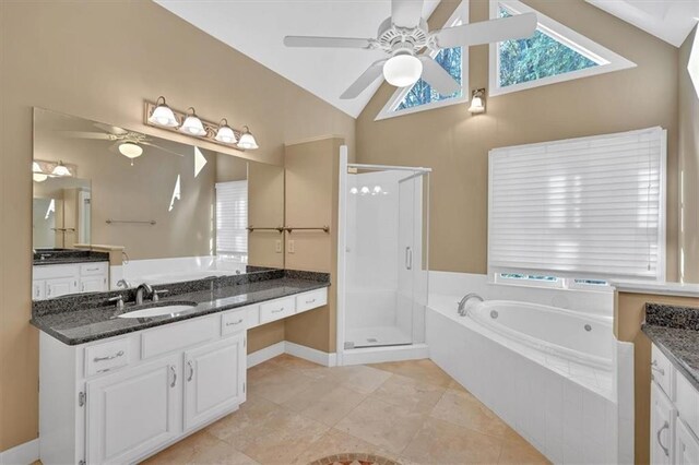 bathroom with ceiling fan, separate shower and tub, lofted ceiling, and vanity