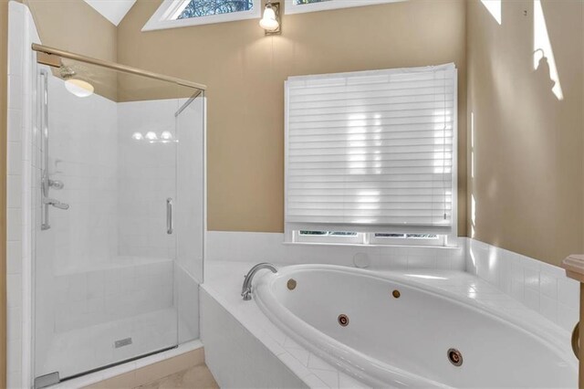 bathroom with independent shower and bath and vaulted ceiling