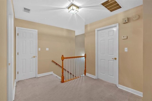 hallway with light colored carpet