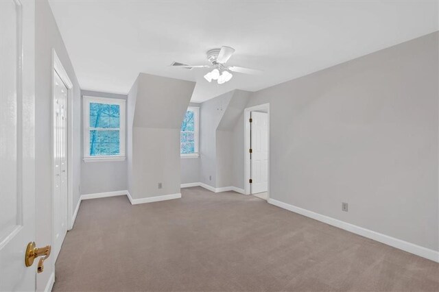 bonus room featuring ceiling fan, carpet floors, and lofted ceiling