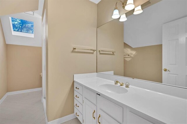 bathroom featuring vanity, a skylight, and tile patterned floors