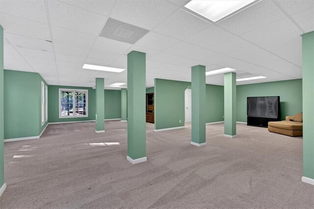 basement featuring carpet and a drop ceiling