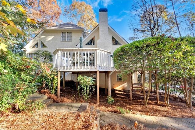 back of house featuring a wooden deck