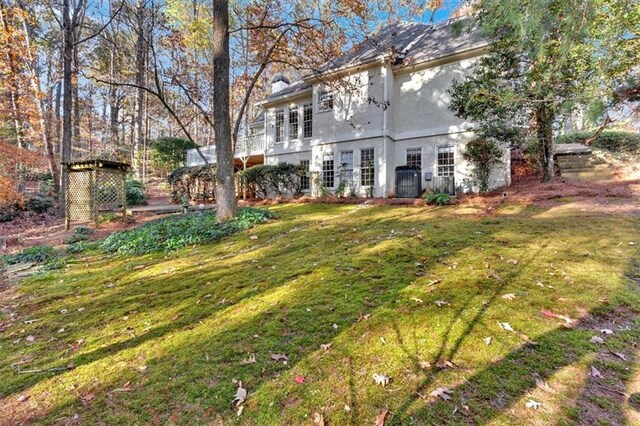 rear view of house with a lawn