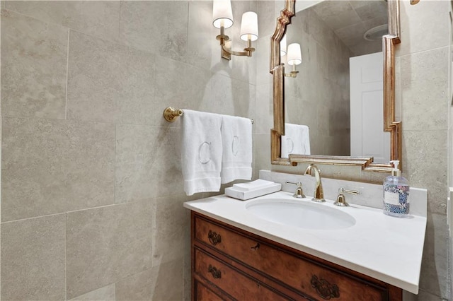 bathroom with vanity and tile walls