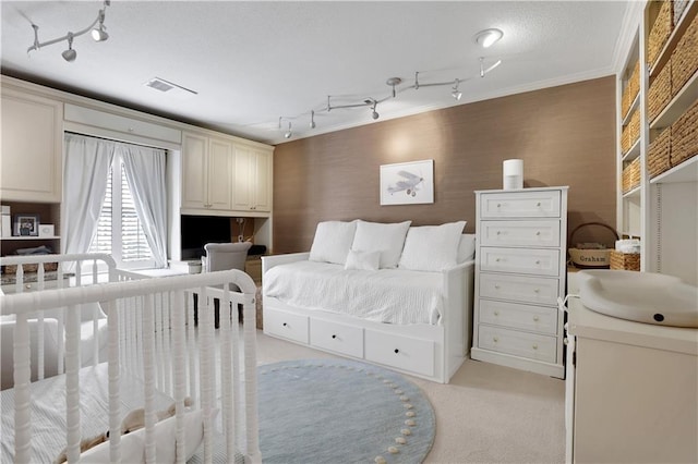 bedroom featuring a textured ceiling, crown molding, visible vents, and light carpet