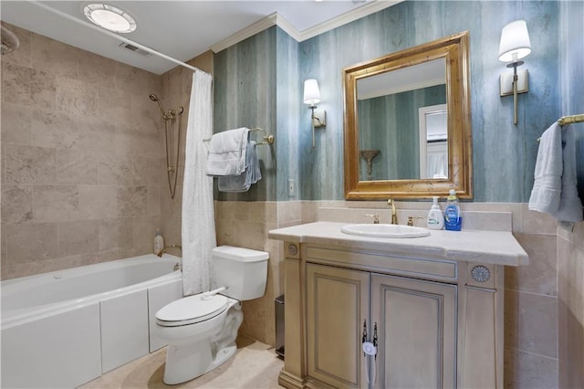 full bath featuring visible vents, toilet, shower / bath combo, tile walls, and vanity