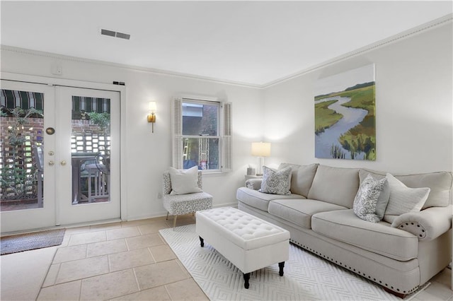 living area with light tile patterned floors, visible vents, baseboards, ornamental molding, and french doors