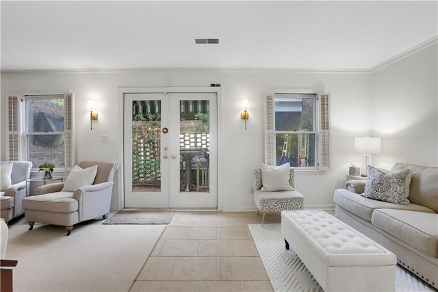 living room with french doors, visible vents, and ornamental molding