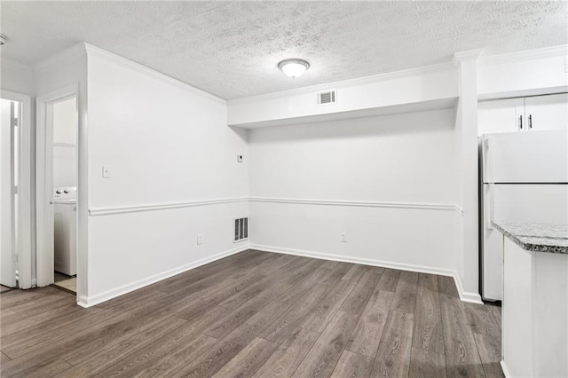 1931 Brian Way, Decatur, GA 30033 - unfurnished dining area with dark wood-style flooring, crown molding, a textured ceiling, and baseboards