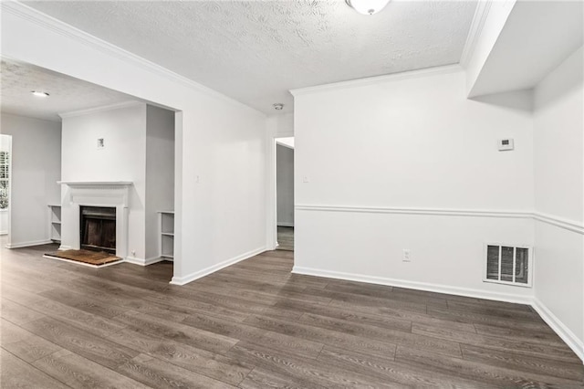 1931 Brian Way, Decatur, GA 30033 - unfurnished living room with a textured ceiling, wood finished floors, ornamental molding, a fireplace with raised hearth, and baseboards