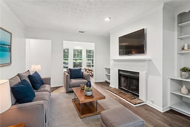 1931 Brian Way, Decatur, GA 30033 - living area featuring wood finished floors, built in shelves, crown molding, baseboards, and a fireplace with raised hearth
