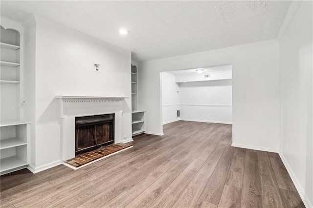 1931 Brian Way, Decatur, GA 30033 - unfurnished living room with built in shelves, wood finished floors, baseboards, and crown molding