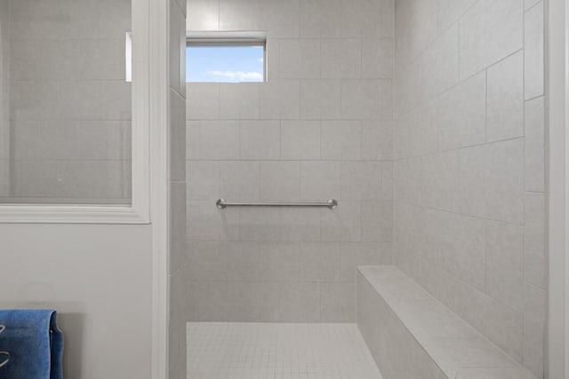 bathroom with tiled shower