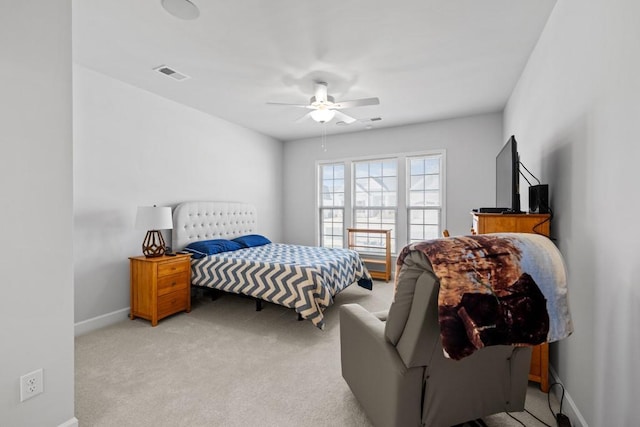 bedroom featuring a ceiling fan, baseboards, visible vents, and light carpet