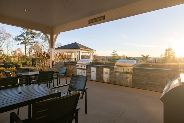 view of patio featuring a gazebo, area for grilling, and fence