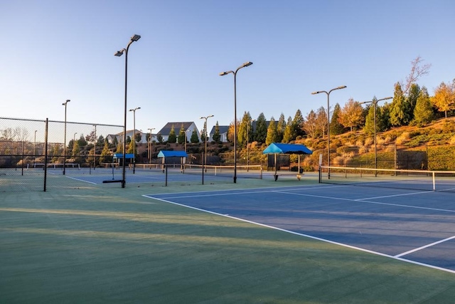 view of tennis court featuring fence