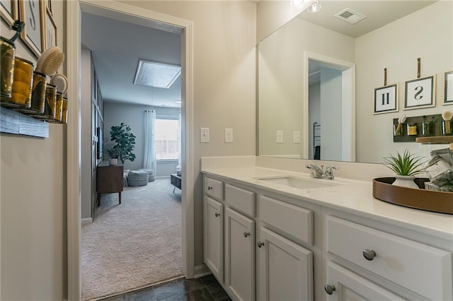 bathroom with baseboards, visible vents, and vanity