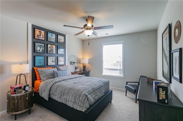 carpeted bedroom featuring ceiling fan, visible vents, and baseboards