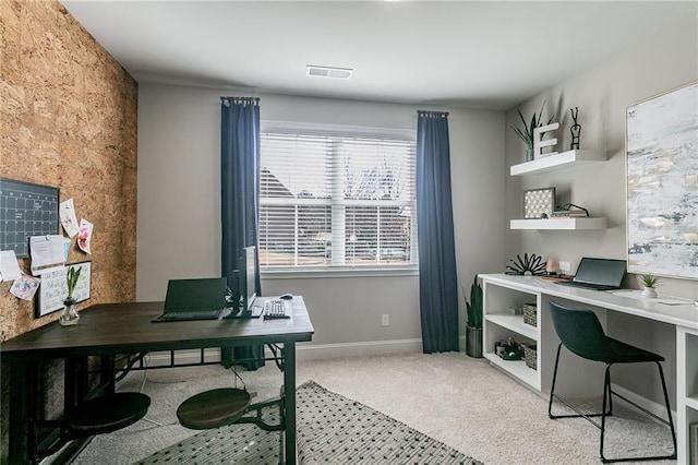 carpeted office space with visible vents and baseboards