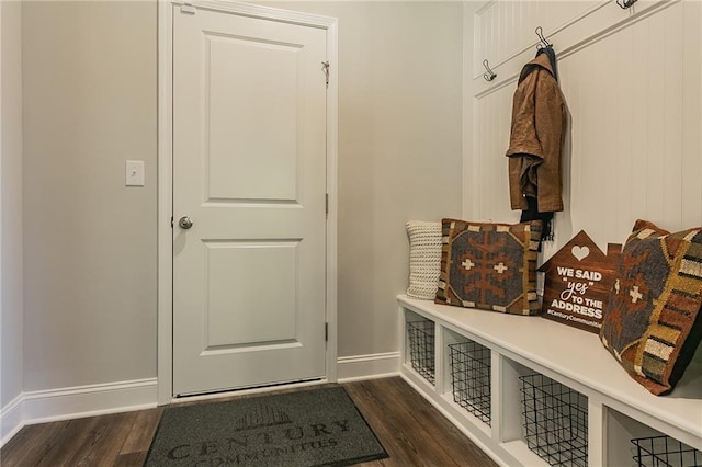 mudroom featuring dark wood-type flooring and baseboards