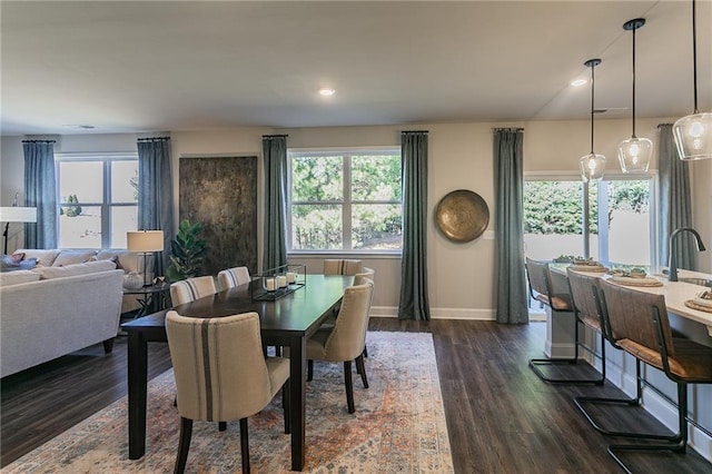 dining room with dark wood-type flooring, recessed lighting, and baseboards