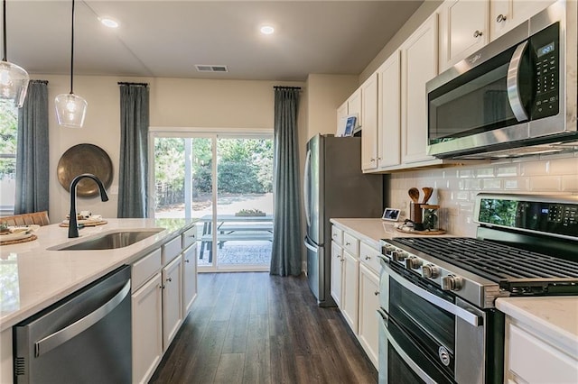 kitchen with white cabinets, visible vents, stainless steel appliances, and a sink