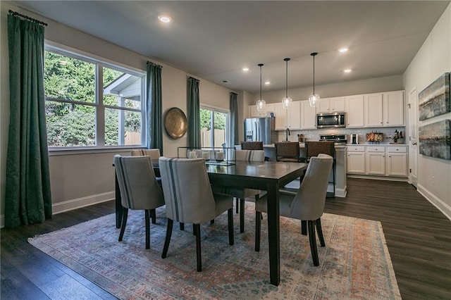 dining space featuring recessed lighting, dark wood finished floors, and baseboards