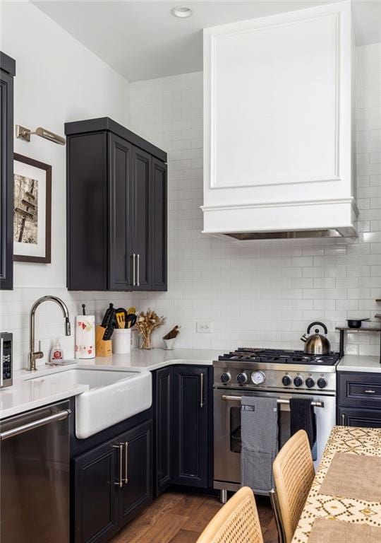 135 Mado Ln, Chattahoochee Hills, GA 30268 - kitchen with stainless steel appliances, light countertops, decorative backsplash, and a sink
