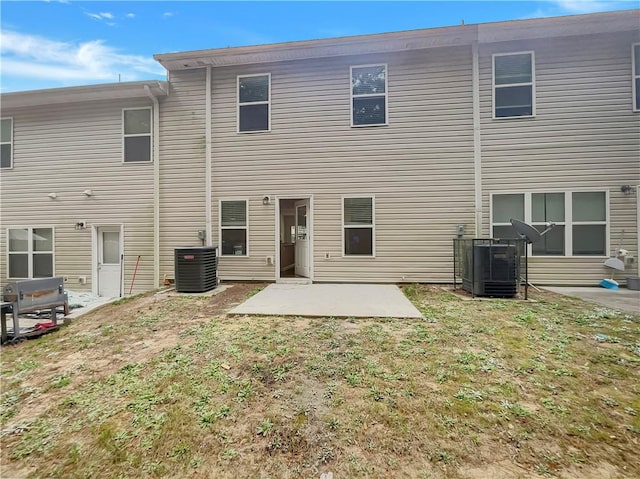 6077 Oakley Rd, Union City, GA 30291 - back of house with cooling unit, a patio, and a lawn
