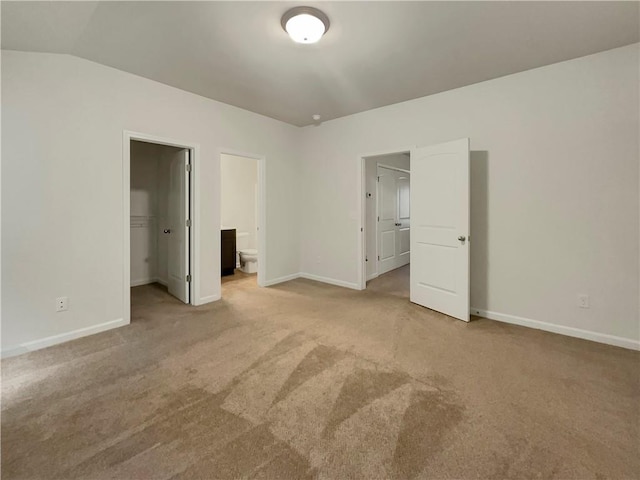 6077 Oakley Rd, Union City, GA 30291 - unfurnished bedroom featuring lofted ceiling, connected bathroom, a spacious closet, light carpet, and a closet