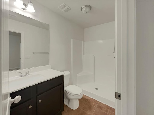6077 Oakley Rd, Union City, GA 30291 - bathroom with walk in shower, tile patterned floors, vanity, and toilet
