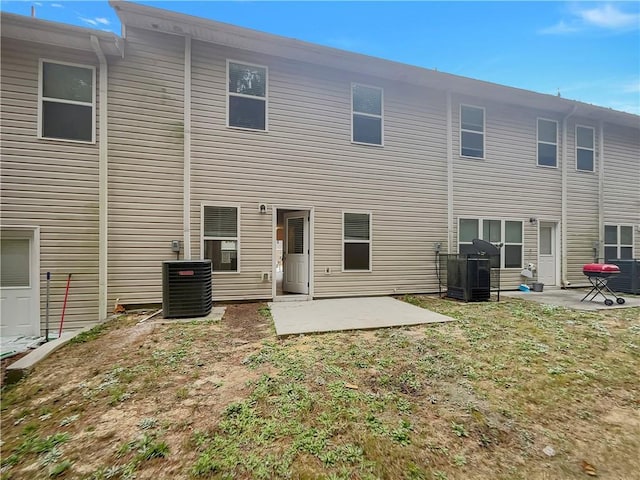 6077 Oakley Rd, Union City, GA 30291 - back of property with central AC unit, a patio area, and a lawn