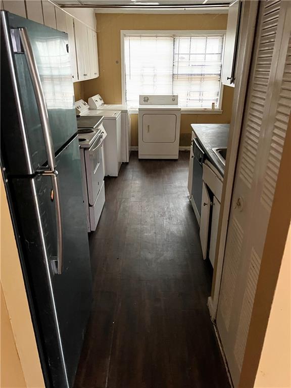 6354 Shannon Pkwy Unit 30D, Union City, GA 30291 - kitchen featuring white cabinets, dark wood-type flooring, appliances with stainless steel finishes, and washing machine and clothes dryer