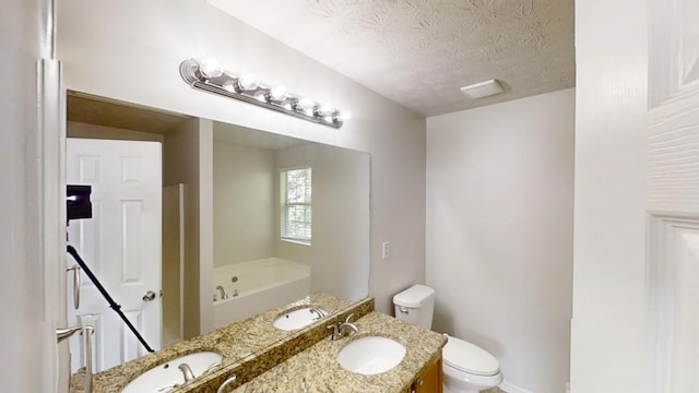 488 Barclay Ct, Stone Mountain, GA 30083 - bathroom featuring a bath, a textured ceiling, and double vanity