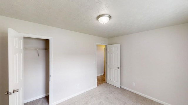 488 Barclay Ct, Stone Mountain, GA 30083 - unfurnished bedroom with carpet flooring, a closet, and a textured ceiling