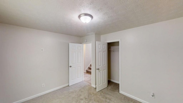 488 Barclay Ct, Stone Mountain, GA 30083 - unfurnished bedroom featuring light colored carpet, a closet, and a textured ceiling