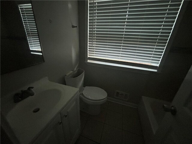 bathroom featuring tile patterned floors, vanity, and toilet