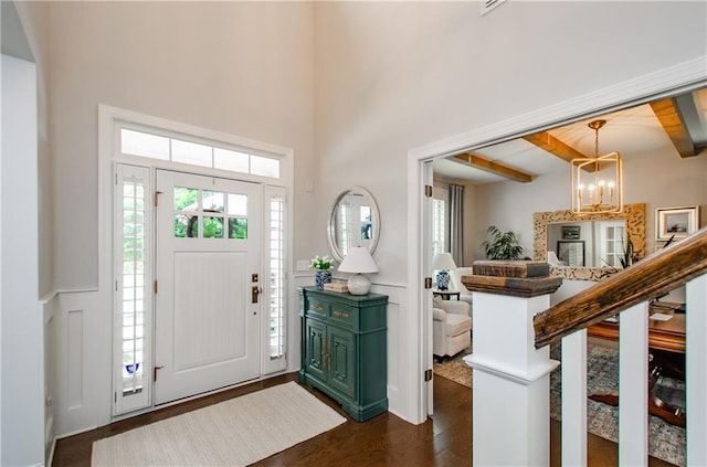 2535 Castlerock Ct, Cumming, GA 30041 - entryway with dark wood finished floors, beam ceiling, and a chandelier